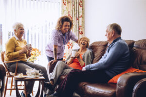 Three,Seniors,Enjoying,Tea,And,Cake,In,The,Care,Home.